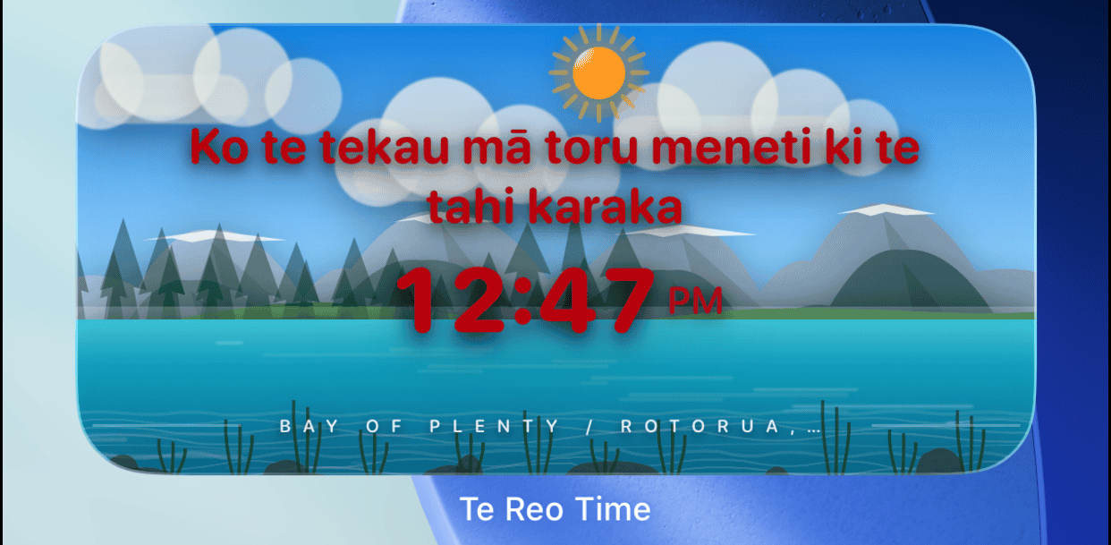 Te Reo Time widget on iPhone home screen showing 12:47 PM with mountain and water landscape