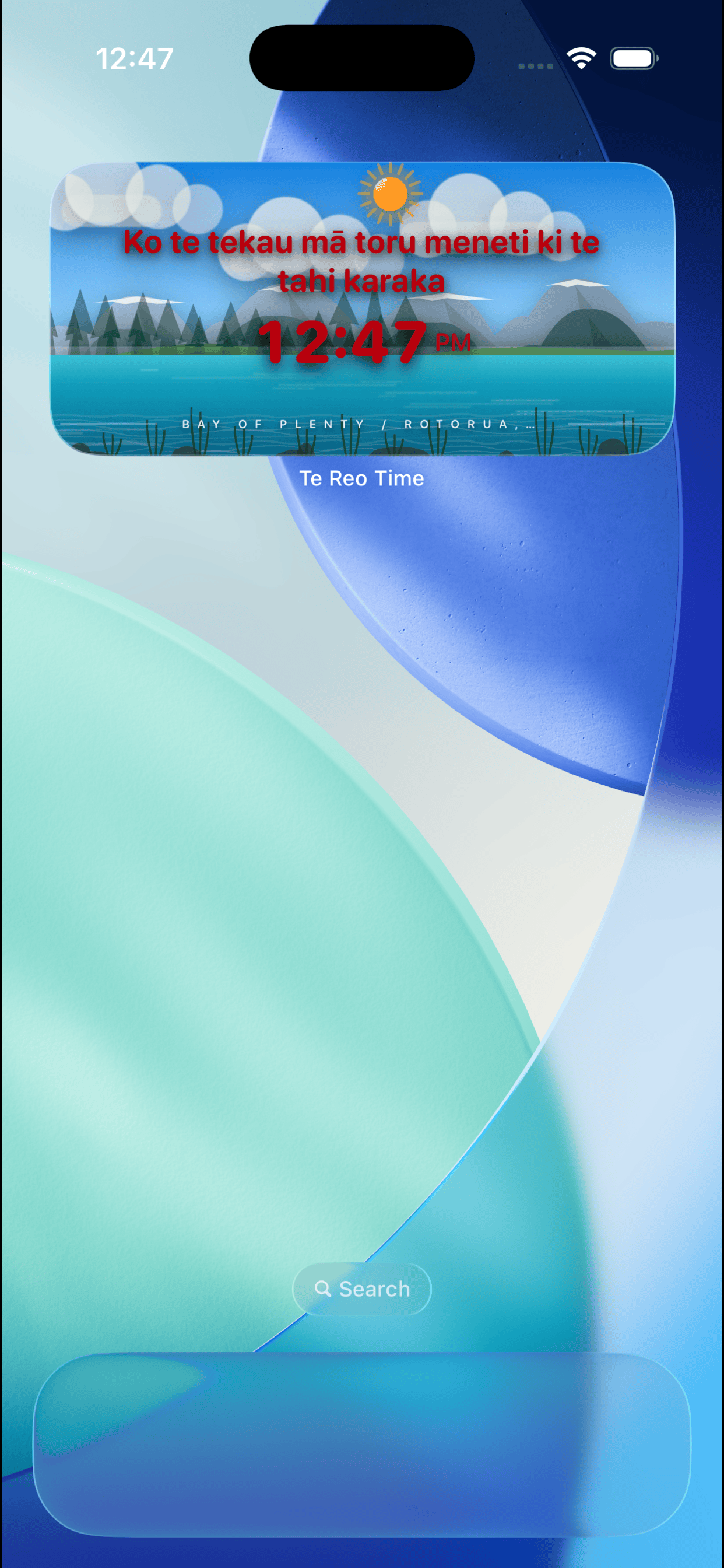 Te Reo Time widget during day showing bright sun, clouds and water landscape with time in red